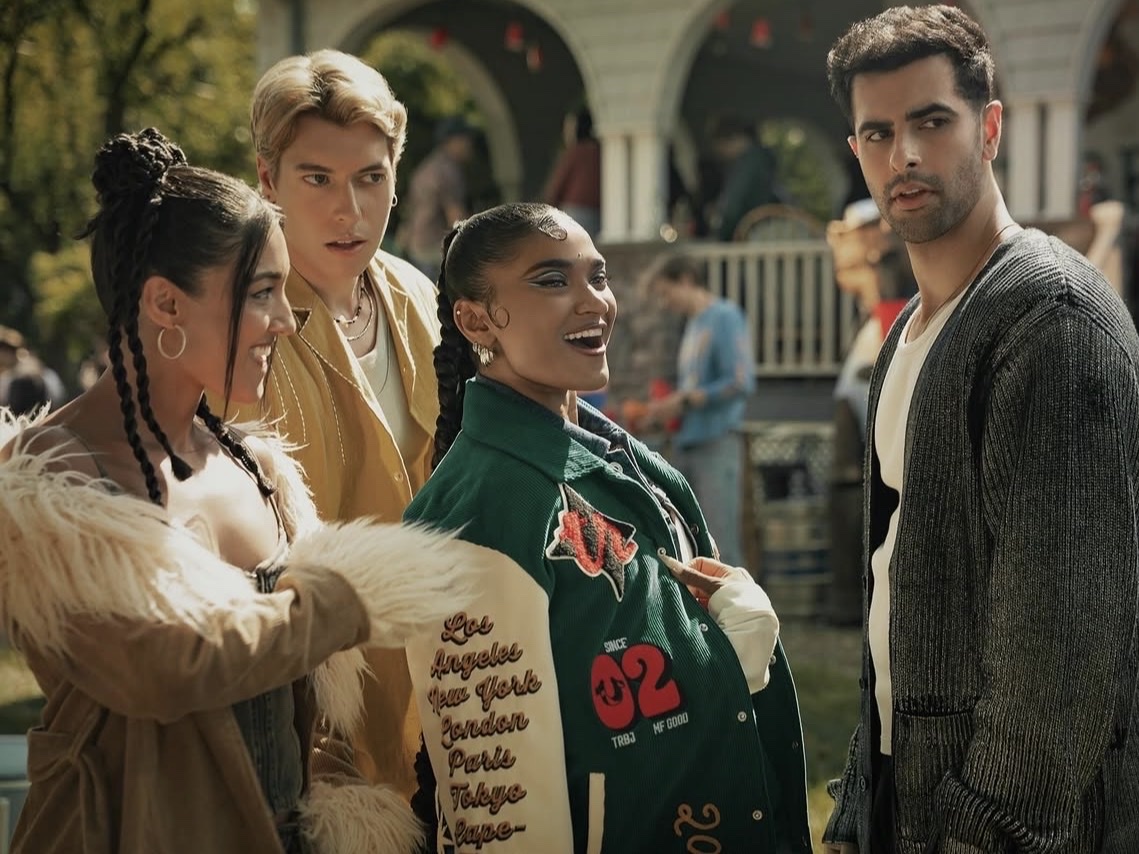 Shivani, in a fur-trimmed coat with braided buns, in a still from the Netflix feature film Best of the Best